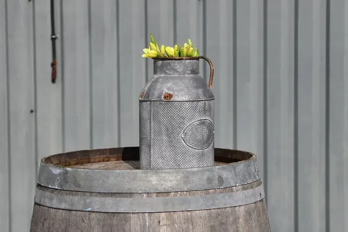Rights Managed : CJ12 5352 Yellow tulips in a jug on a barrell Rights Managed : CJ12 5352 Yellow tulips in a jug on a barrell